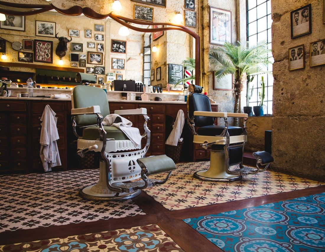 The front room of the shop with its iron chairs and checked floor