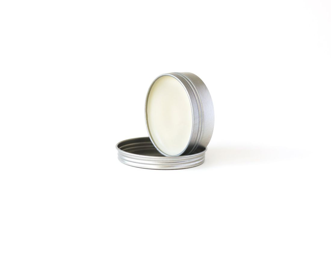 An open tin of beard balm