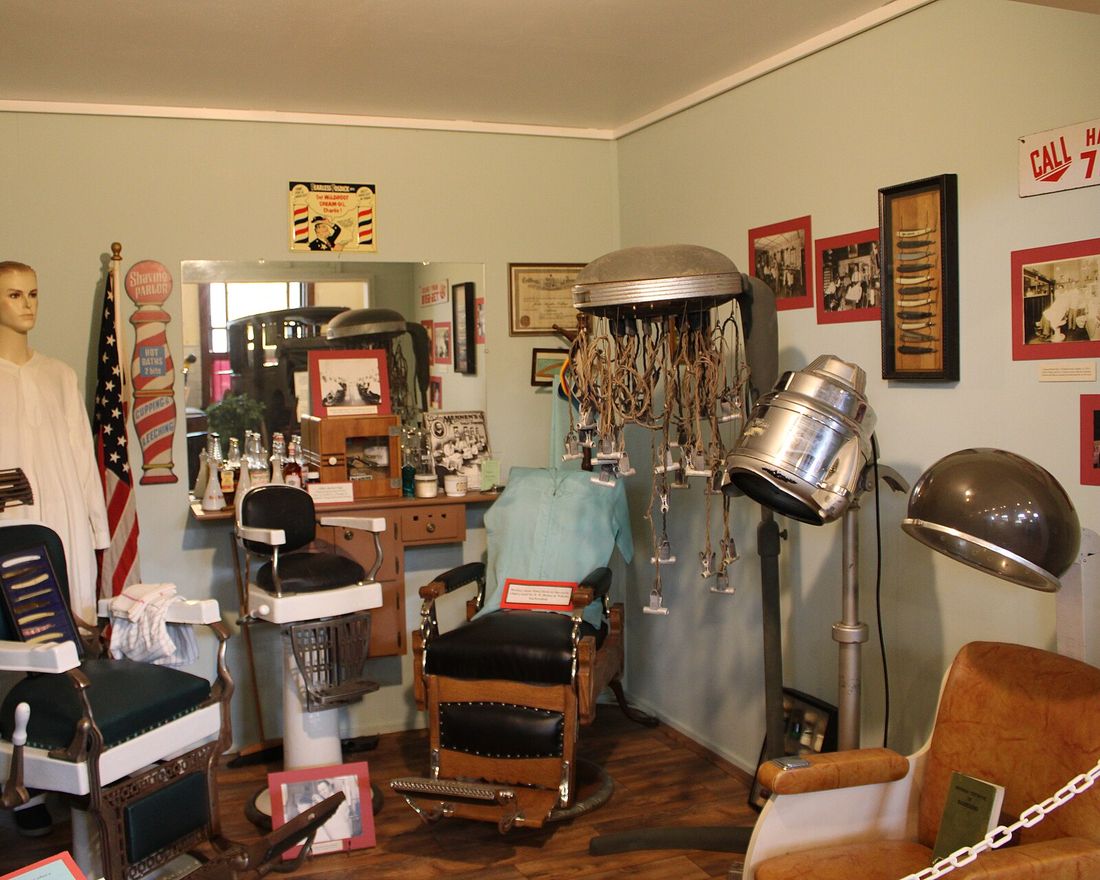 The shop interior in the 1970s, with older chairs and cabinets.